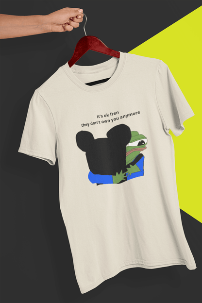 An off-white T-shirt with Mickey Mouse hugging a cute Apu in the middle, saying &quot;it&#39;s ok fren, they don&#39;t own you anymore&quot;, held by a hand against a split black and yellow background.