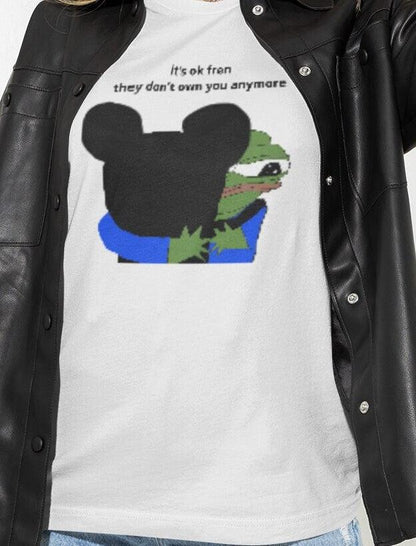 A woman wears a white T-shirt featuring Mickey Mouse hugging a cute Apu in the middle, saying &quot;it&#39;s ok fren, they don&#39;t own you anymore&quot;.