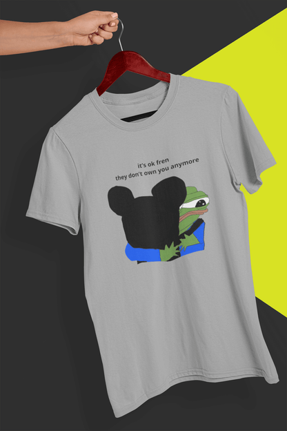 A gray T-shirt with Mickey Mouse hugging a cute Apu in the middle, saying &quot;it&#39;s ok fren, they don&#39;t own you anymore&quot;, held by a hand against a split black and yellow background.