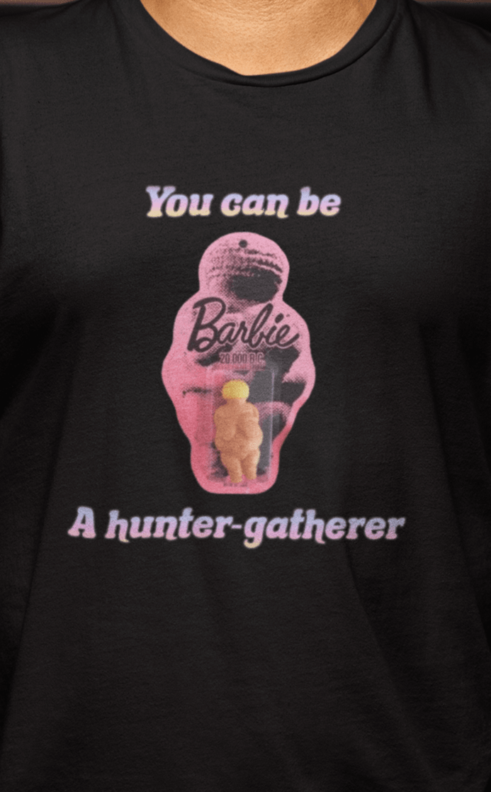 A woman wears a black T-shirt featuring the venus impudique that says &quot;Barbie You can be a hunter-gatherer&quot;.